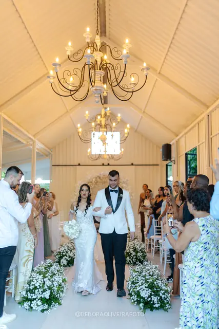 Newlyweds leaving the ceremony through sparklers at Celeiro Blanc