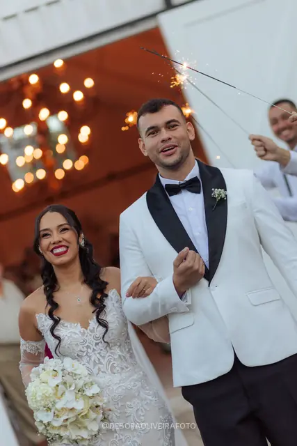 Newlyweds leaving the ceremony through sparklers at Celeiro Blanc