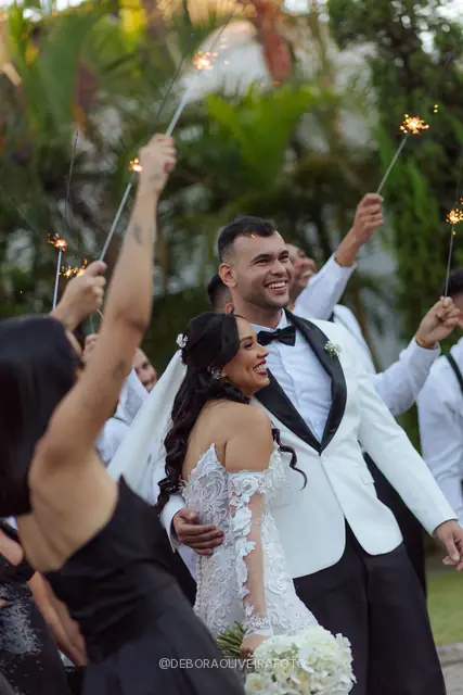Newlyweds leaving the ceremony through sparklers at Celeiro Blanc